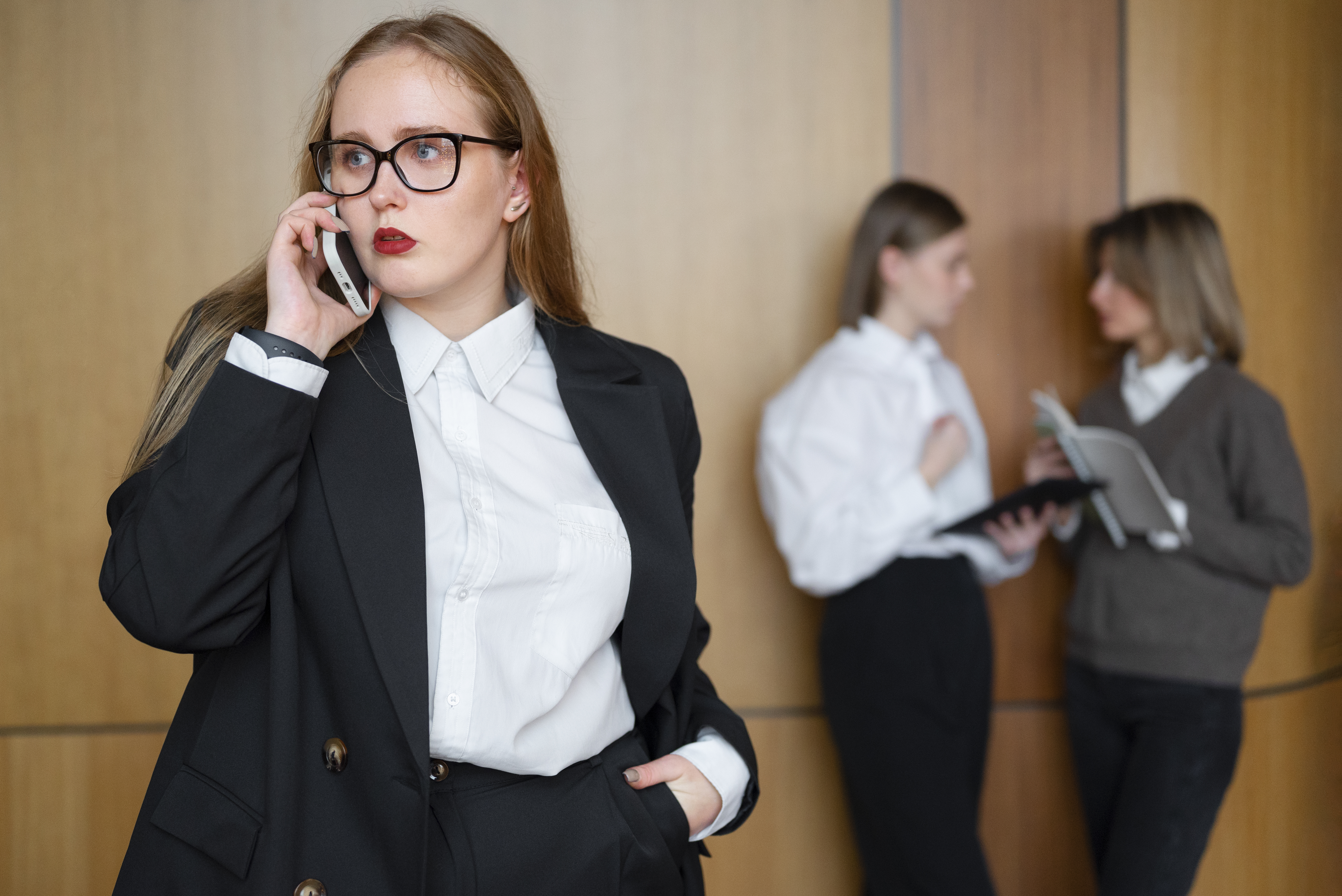 professional-woman-stylish-suit-office-using-smartphone