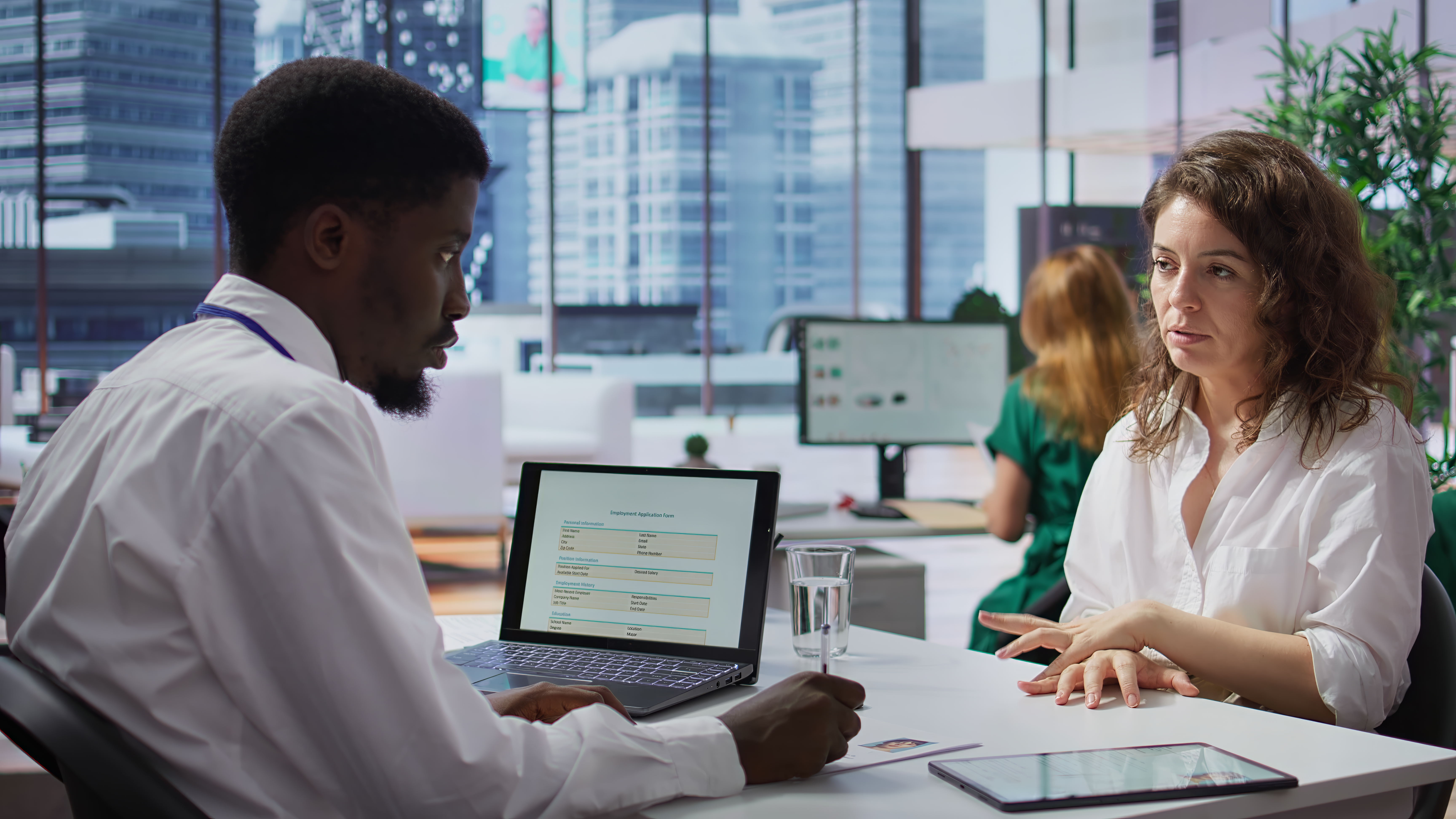 Staff interviewing woman applicant job seeker in high end office, evaluating her qualifications and talent. HR recruiter looking for personnel with experience in business administration. Camera B.