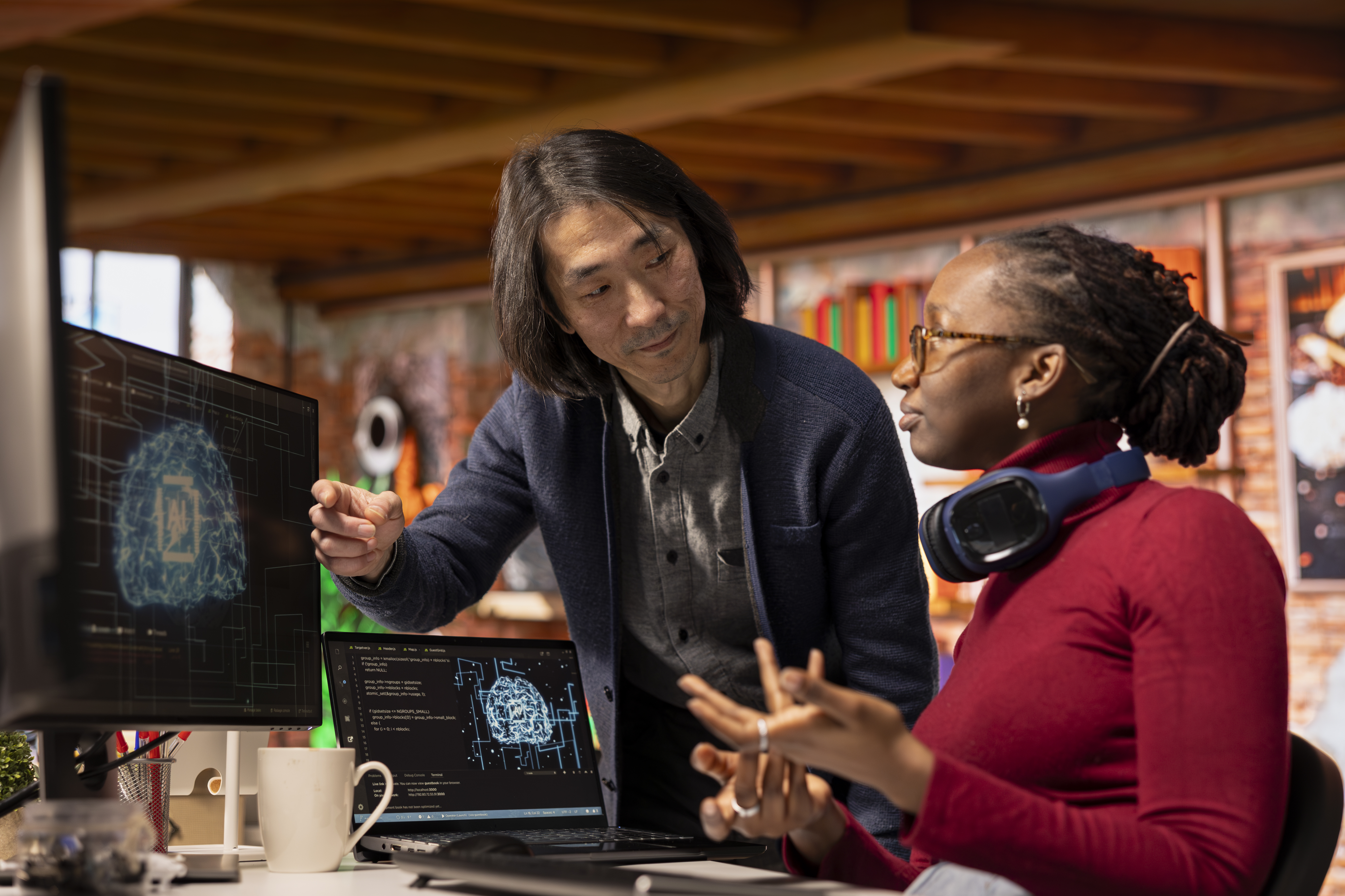 AI startup office chief technology officer overseeing programmer building application. Senior manager assisting worker in artificial intelligence software development agency, offering advice
