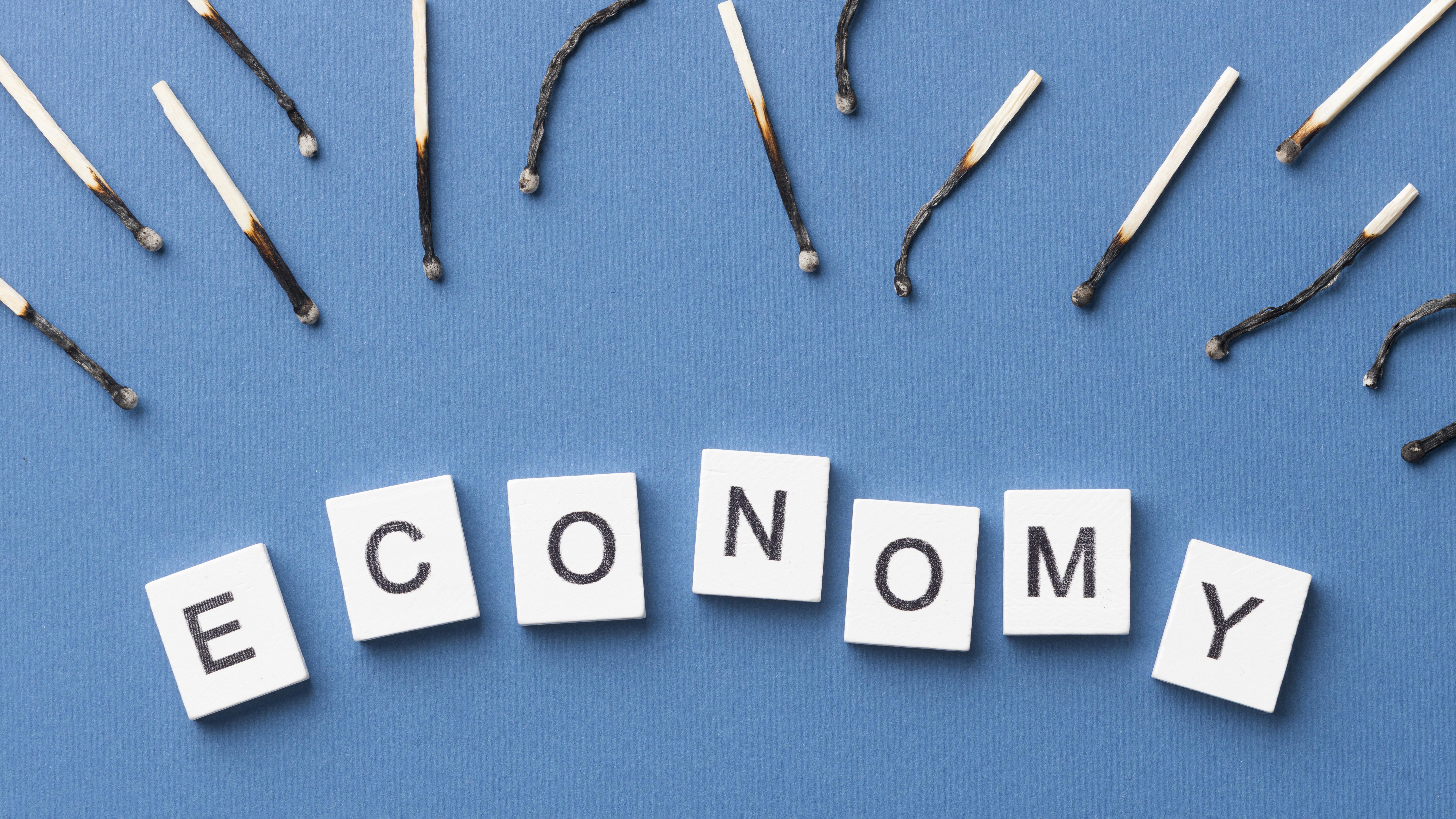 burnt-matches-arrangement-with-economy-word