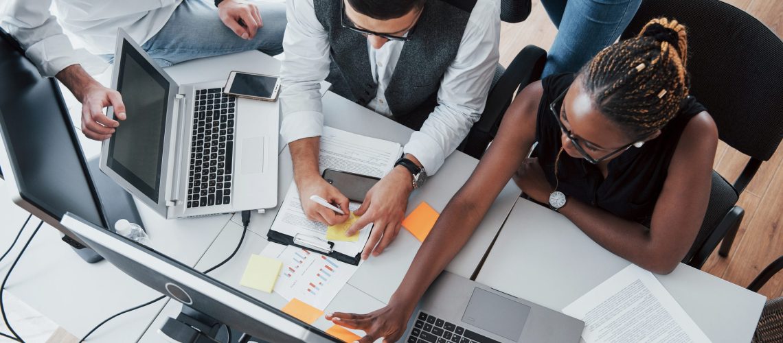 A group of multinational busy people working in the office. Height view
