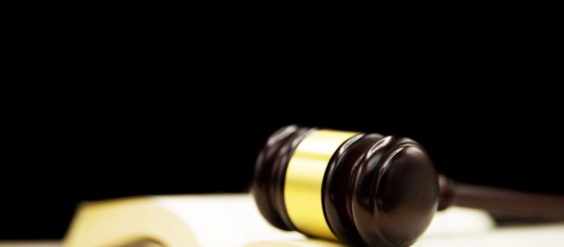 Judges gavel on book and wooden table. Law and justice concept background.