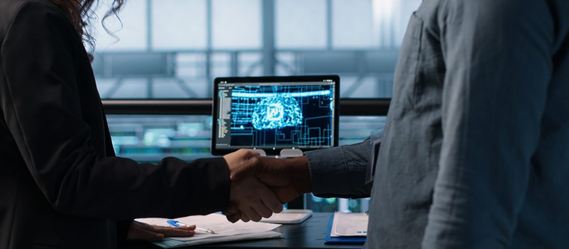 Manager meeting with client in data center using artificial intelligence tech, reaching deal. People doing handshake in AI based server farm after checking files and finishing transaction, camera A