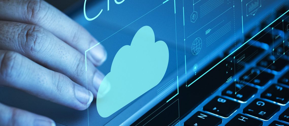 Woman scrolling on a laptop