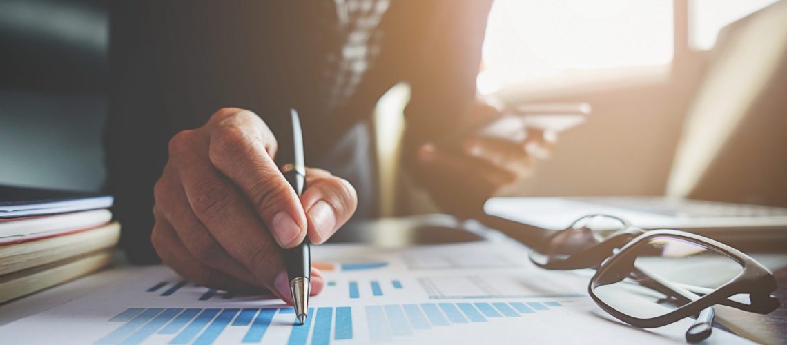 Business concept. Business people discussing the charts and graphs showing the results of their successful teamwork.